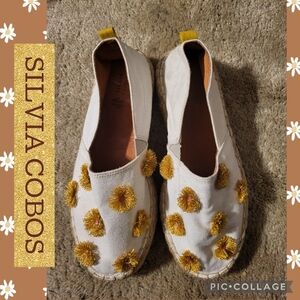 Silvia Cobos Cream Espadrilles with Gold Pom-Pom Accents